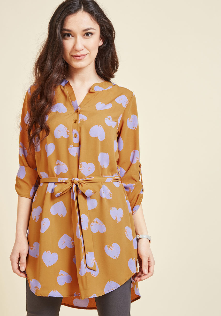  - This navy blue tunic is always on double-duty, acting as a piece that's equal parts fun and functional! Perfect for daytime with its tab sleeves and buttoned V-neck, this ModCloth-exclusive top also flaunts a flirty matching sash and lovely taupe flowers 