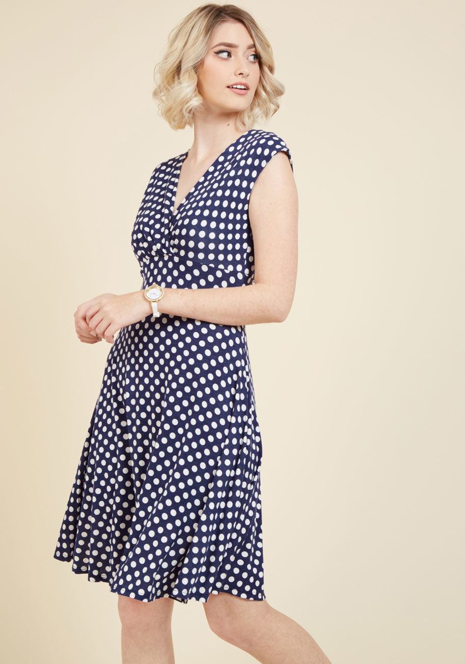  - Today marks a special occasion - one to be celebrated by wearing this polka-dotted dress - the day that your intern expertise grows into a full-fledged career! Flaunting cap sleeves and surplice neckline, this navy frock is the perfect mark of a chic new 