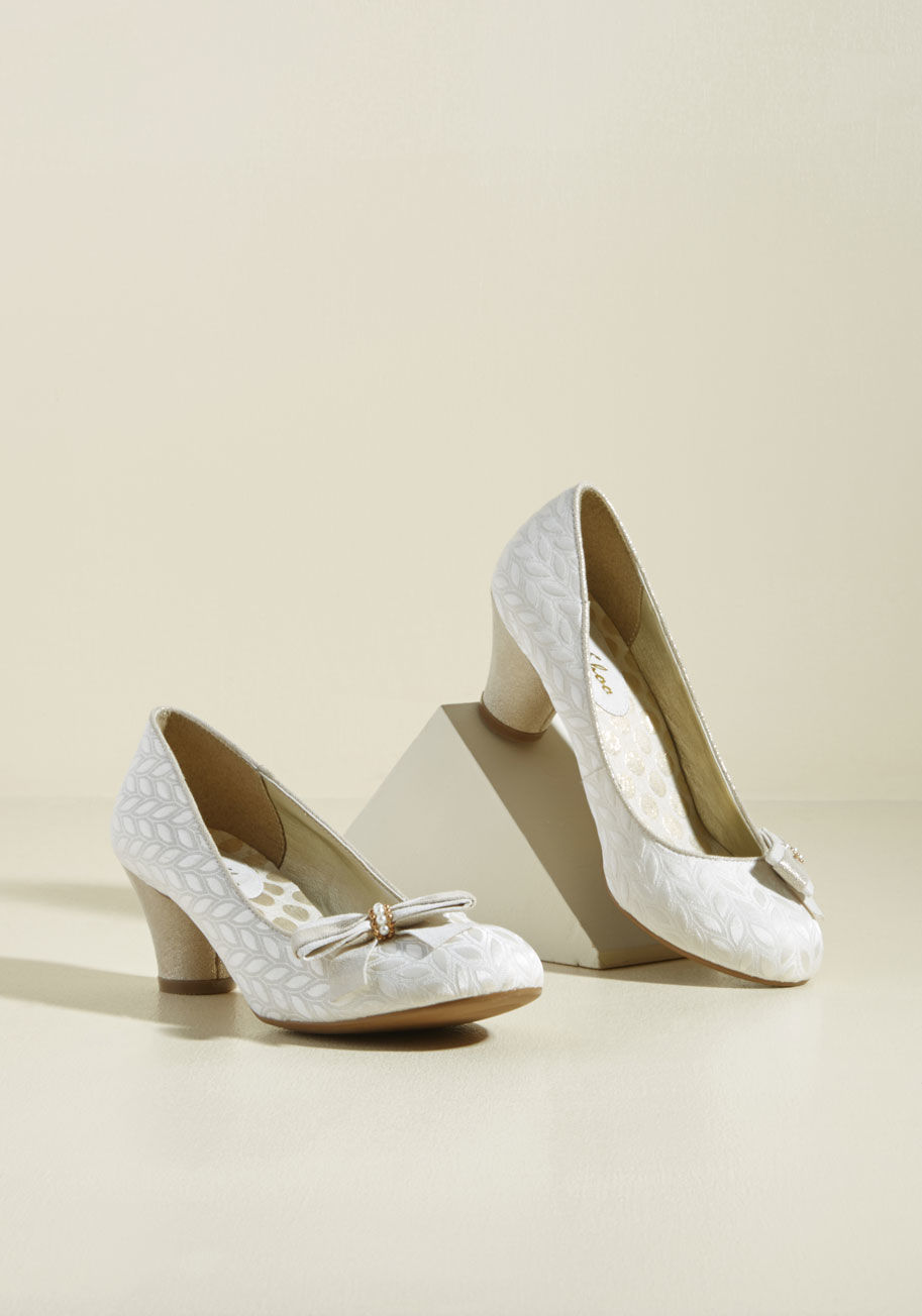 - We estimate that when choose to debut these ivory heels from Ruby Shoo, compliments will range from the proper sort to the purely passionate kind! Tapered, circular pumps sparkling with a champagne hue support the jacquard uppers and bow-topped toes of th