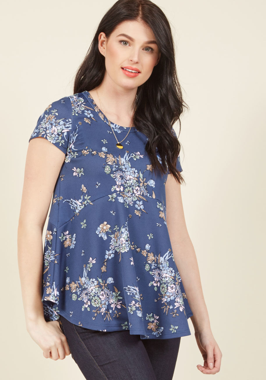  - What do you think when you gaze upon this dusk blue top? Does its muted floral print transport you to faraway meadows? Does its A-line silhouette encourage visions of carefree twirls? One thing is for sure - this ModCloth-exclusive tee's stretch knit guar