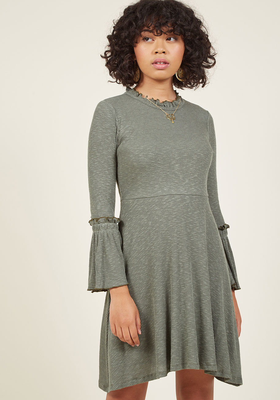  - What's better than an ensemble that brings the boldness yet is still simple to wear? This green dress makes an easy impact with its ruffly neckline, trumpet sleeves, and delicate heathering - elements that are destined to impress!