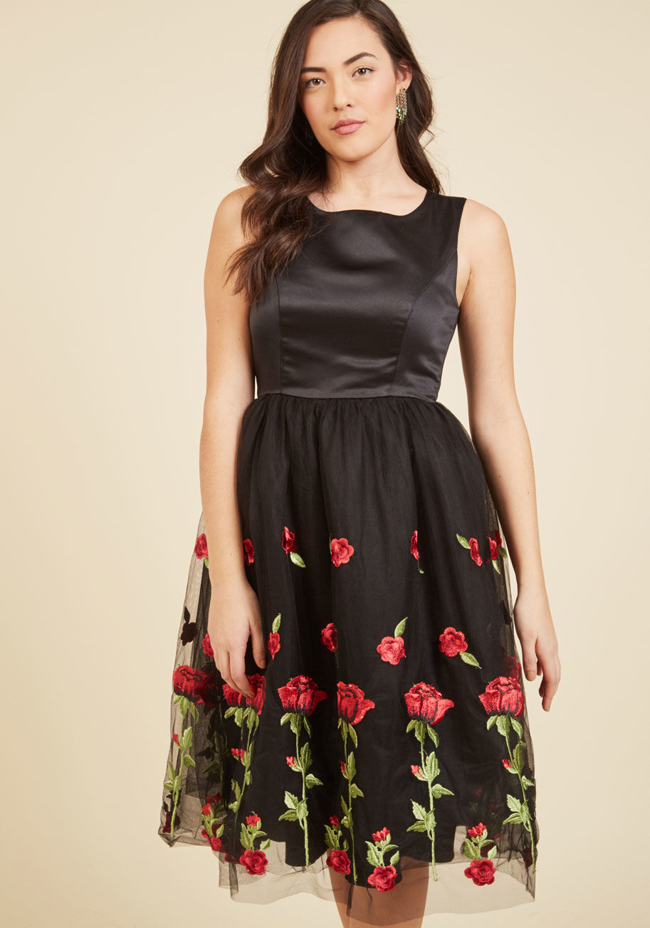  - What's that sound? Ah yes, it's the sweet symphony of praise for your black fit and flare dress! Adulation for this frock's satin bodice and tulle skirt embroidered with bold red roses will ring from the rafters, providing the perfect soundtrack for an ev