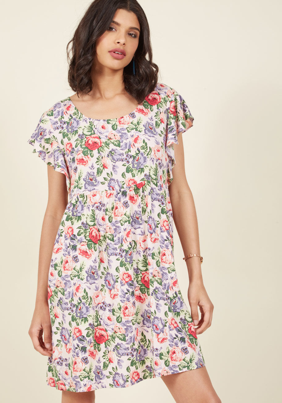  - With positive energy as freely flowing as the flowers dancing down your pastel pink shift dress, your embodiment of bliss is obvious to the eye! Brought to you by British cult brand Motel, this pink, purple, and green patterned piece flaunts ruffled sleev