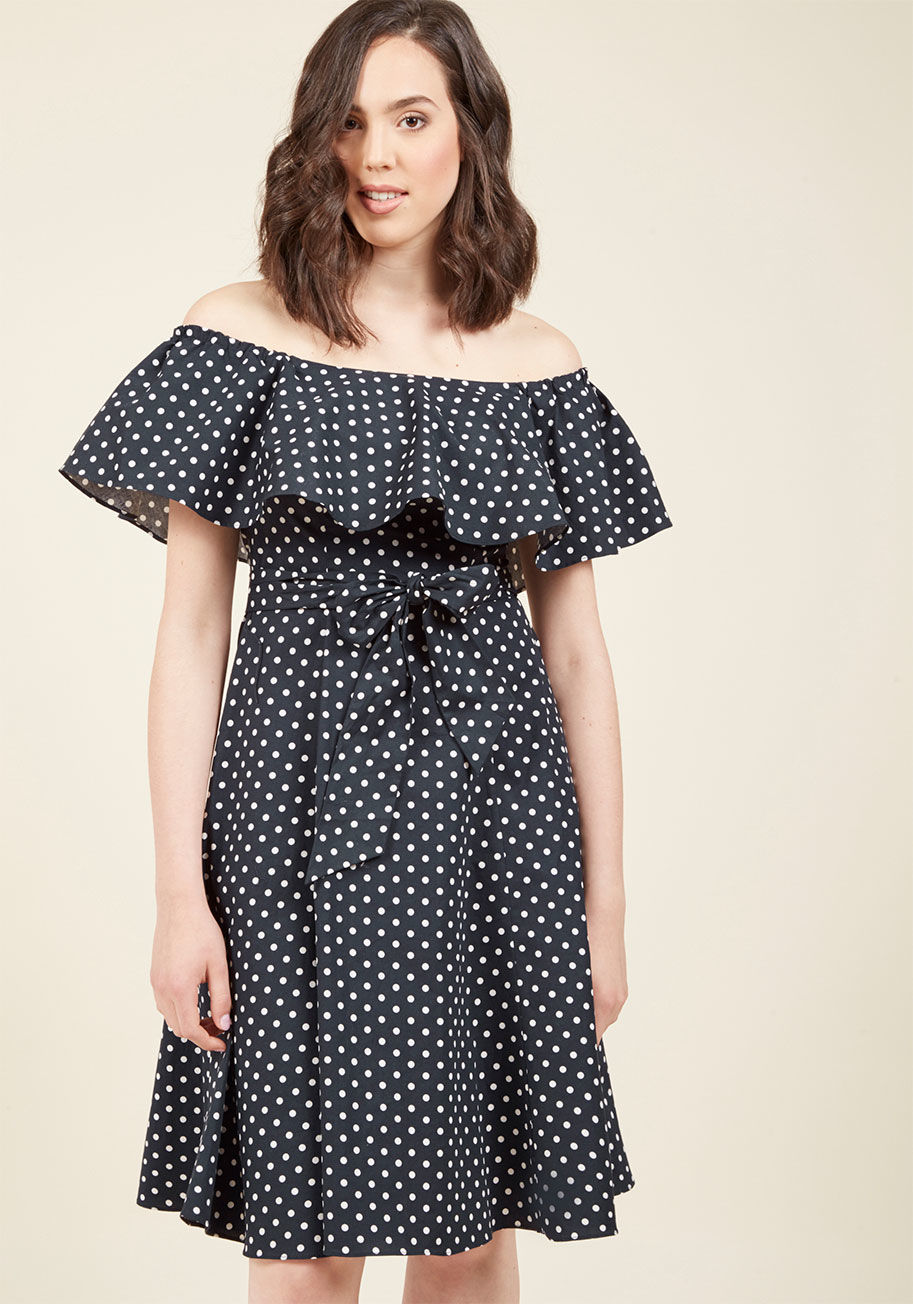  - You can't help but anticipate the personal spin you'll put on this navy midi dress by Donna Morgan! Shall you opt for a sultry ensemble or a playful, vintage-inspired look? With its popover, off-the-shoulder neckline and pockets, this dotted darling is op
