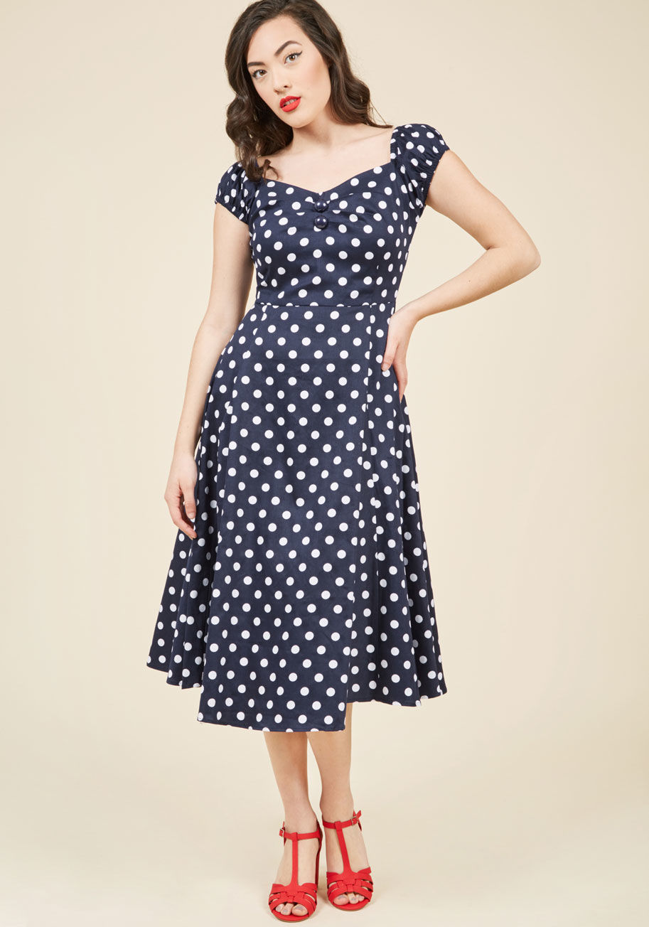  - You have a perpetual crush on vintage-inspired frocks like this lovely red one from Collectif, and rightfully so! Boasting vivid bold white polka dots from top to bottom- and further accentuated by a button-adorned, sweetheart neckline - this classic midi
