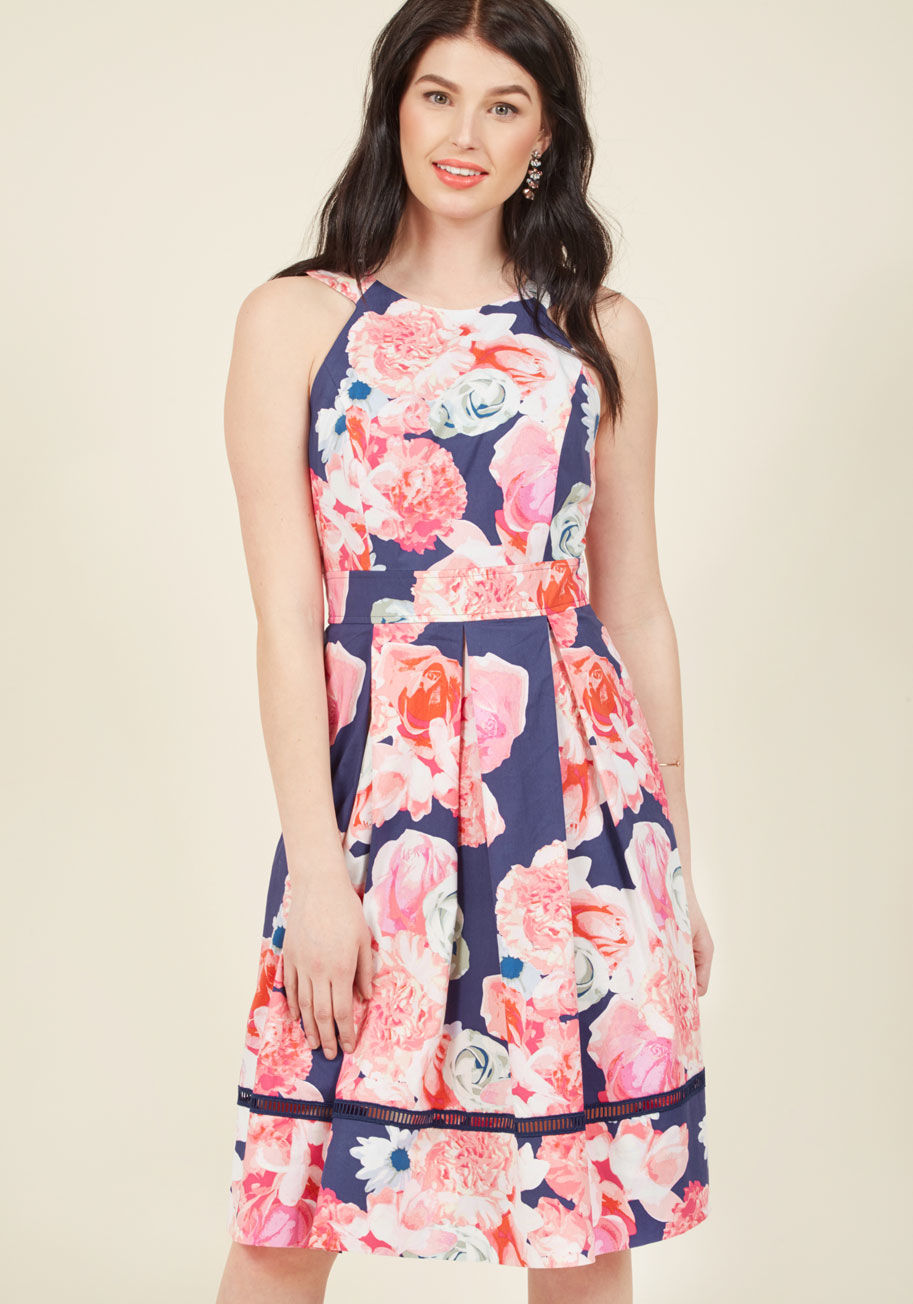  - You have many gifts to share - your winning smile, endless charm, and now the sweet style of this navy blue dress by Eliza J.! Thoughtfully designed with a back cutout, a hint of hemline crocheting, and a pretty pink floral pattern, this pocketed-and-plea