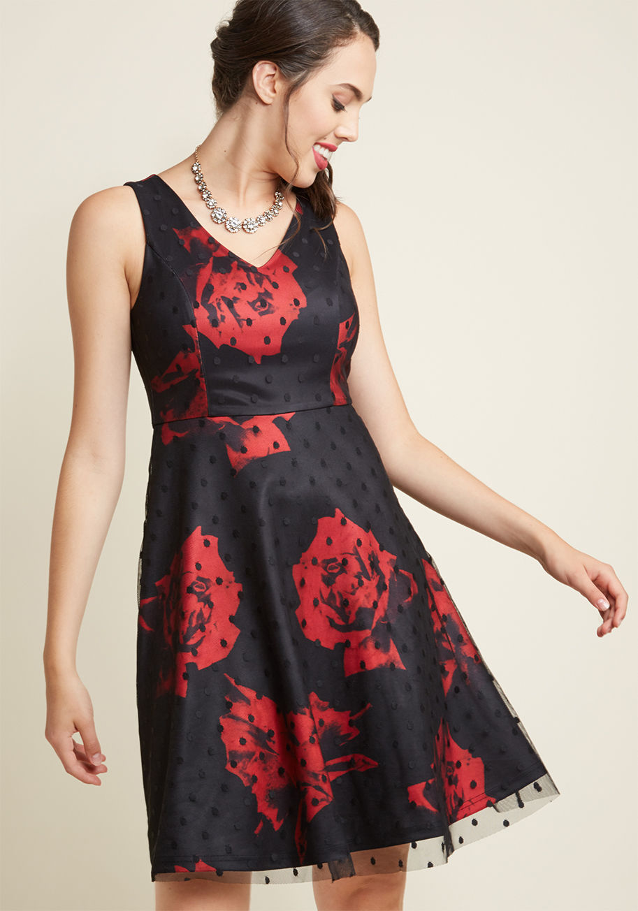  - You want snazzy, you say? This black cocktail dress is here to serve! The V-neckline, sleeveless cut, and A-line silhouette of this frock might be classic, but its pop-art-inspired red rose pattern and dotted mesh overlay are extra-special details that se