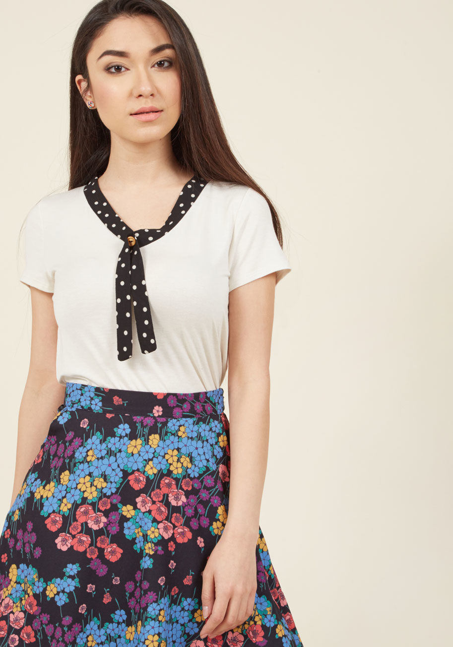  - Your team uses a wide and impressive vocabulary for the grants you write, but when it comes to complimenting this cream-colored shirt, all new language is used! Made from soft jersey knit, touting a breezy silhouette, and topped with a black neckline offe