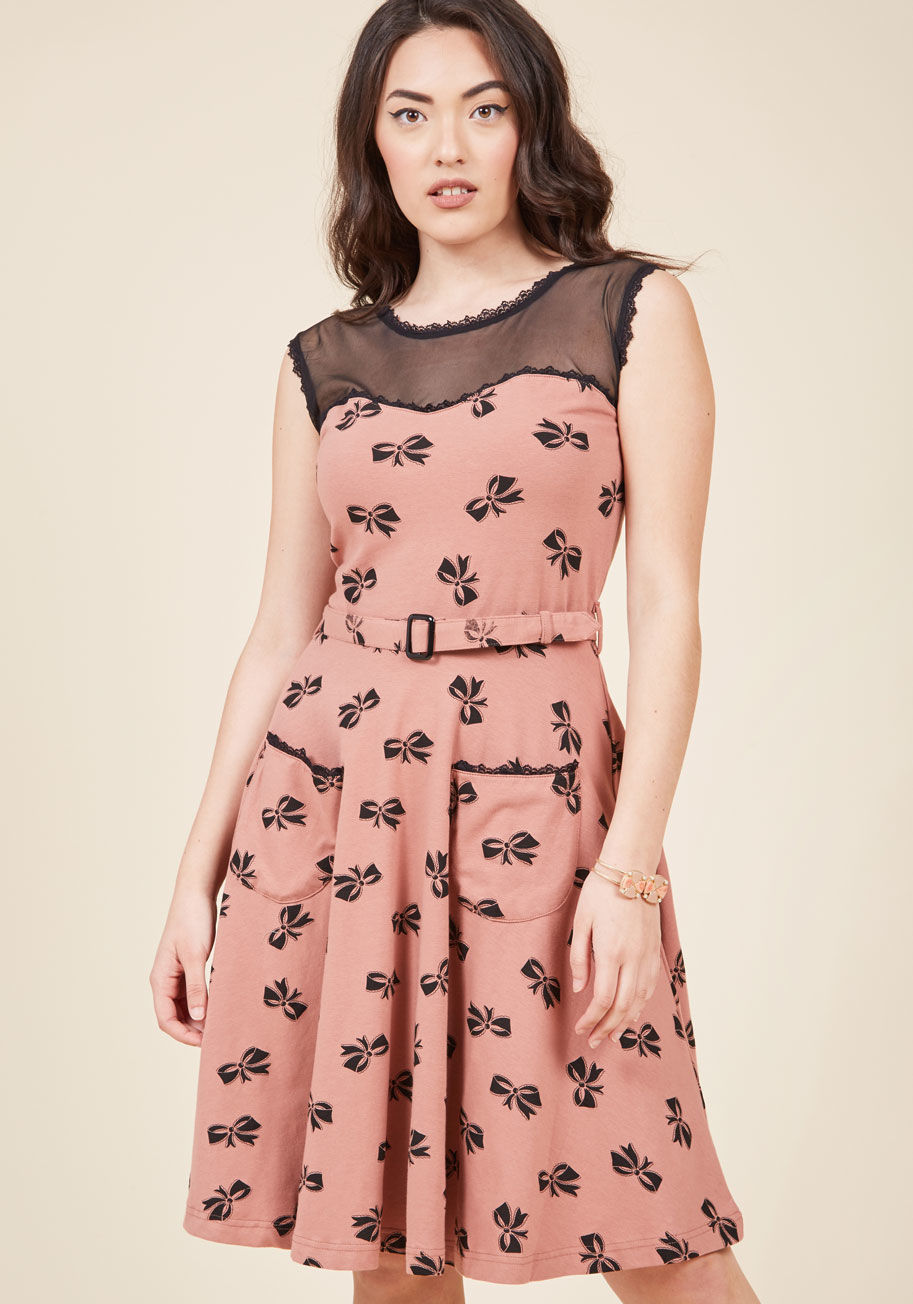  - You're a style blogging revolutionary, easily overcoming the question of what to wear by making this belted dress from California-based Effie's Heart the feature of your next post! This frock's dusty rose knit features a black bow pattern, lace trim, and 
