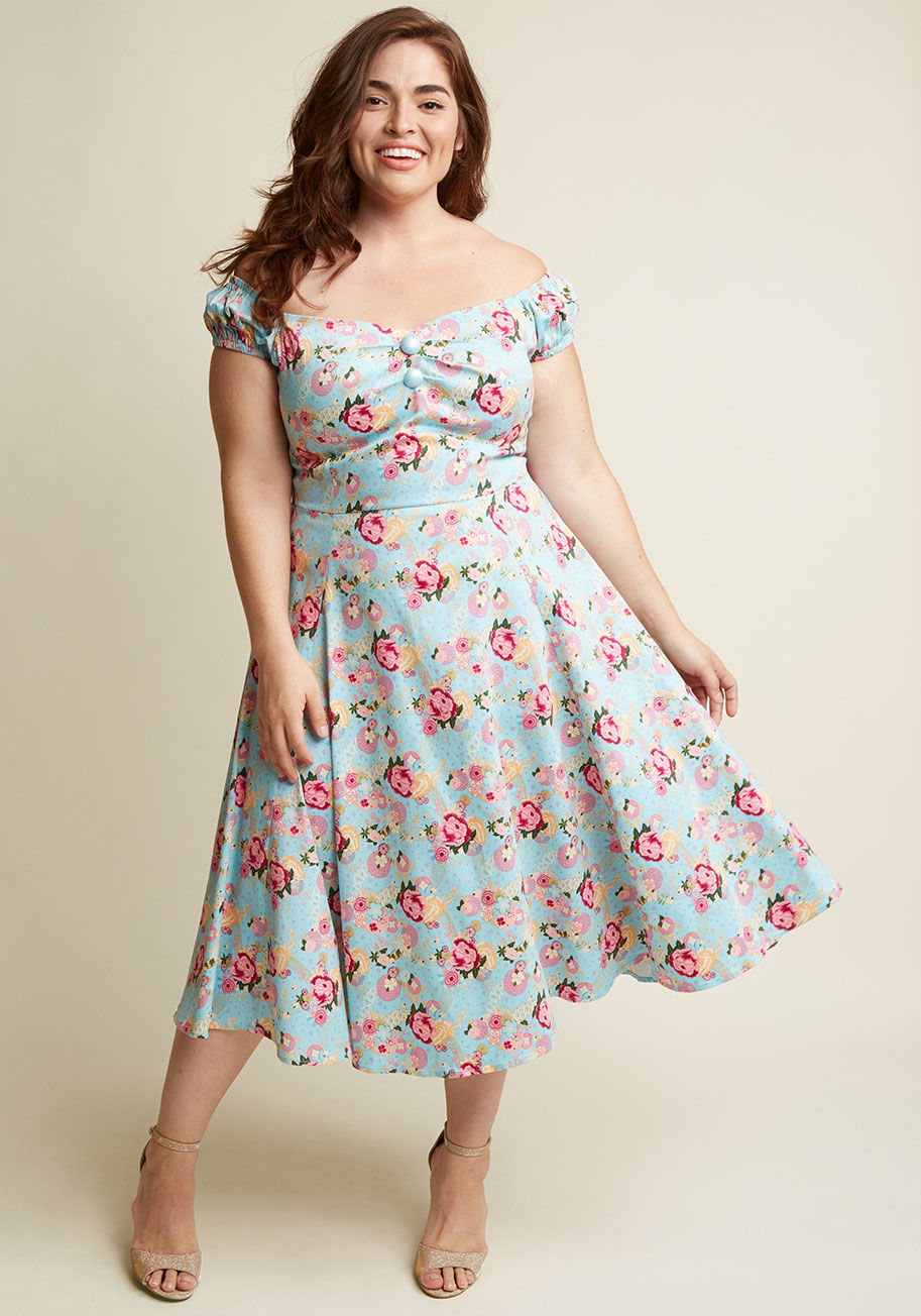  - You&rsquo;re pleased as punch over this off-the-shoulder top and you want to party about it! Style the deep navy hue, printed with pink, maroon, muted yellow, blue, and green birds perched on flowering branches, neckline pleating, and decorative buttons o