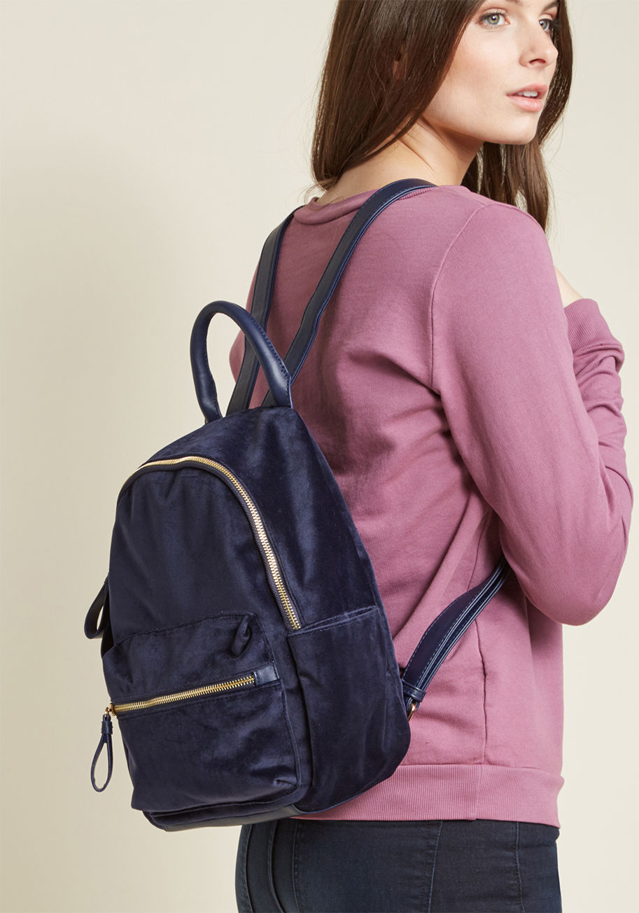 Some flaunt the boldest detail of their ensemble front and center - you sport yours on your back! This navy blue velvet backpack is equipped with faux-leather straps 'n' accents and golden hardware. It's the easiest way of incorporating moxie into the mun by 0766-mid size