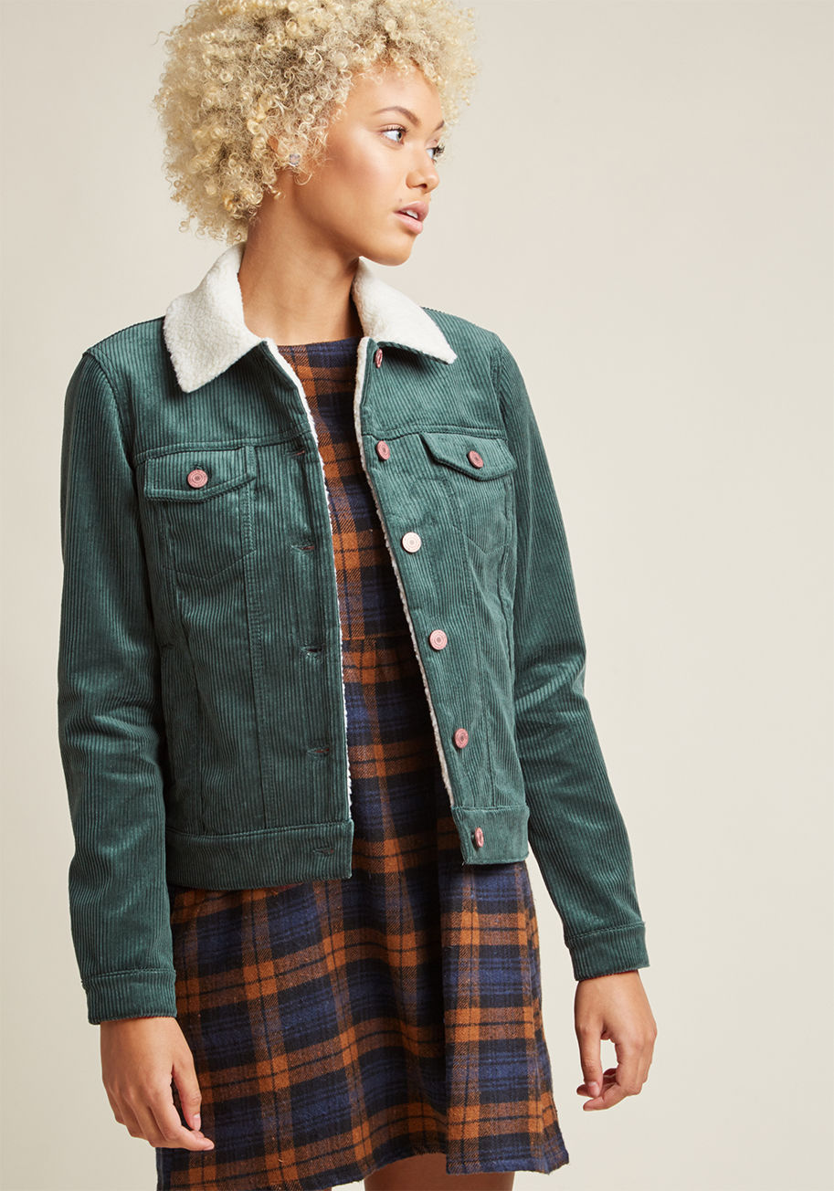 A symphony of rustling leaves is your call to don this corduroy jacket! A faux-shearling collar provides contrast to this classic layer's deep green hue, while a quad of pockets accompany its brassy buttons. There's no better invite to show off this cool- by 10180902