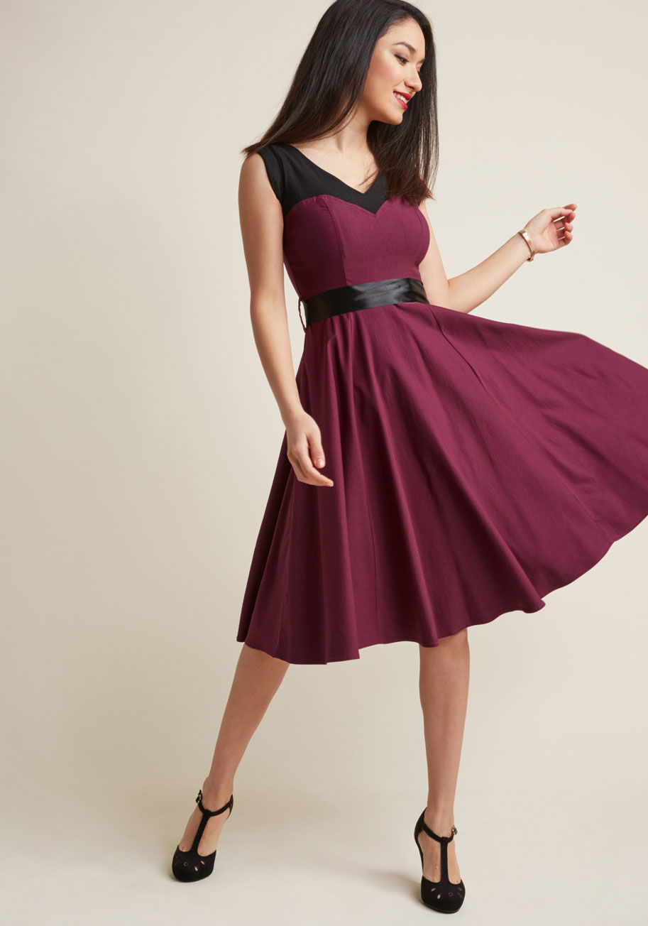 Styling this pinup-inspired dress can only end one way - with marvelousness woven throughout your evening! Boldly colorblocked with black shoulders and a fuchsia body - meeting at the sweetheart neckline - this swingy, ribbon-sash-tied frock is the quicke by 17454