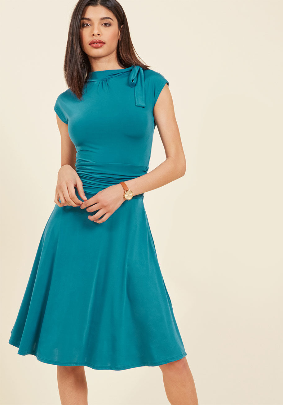 3370 - Jump into this teal frock and meet your darling on the dance floor! The bow-topped neckline of this ModCloth-exclusive look bounces with your every tango step, while the ruched details hug your waist as you flash your footwork! With a retro-infused shape,