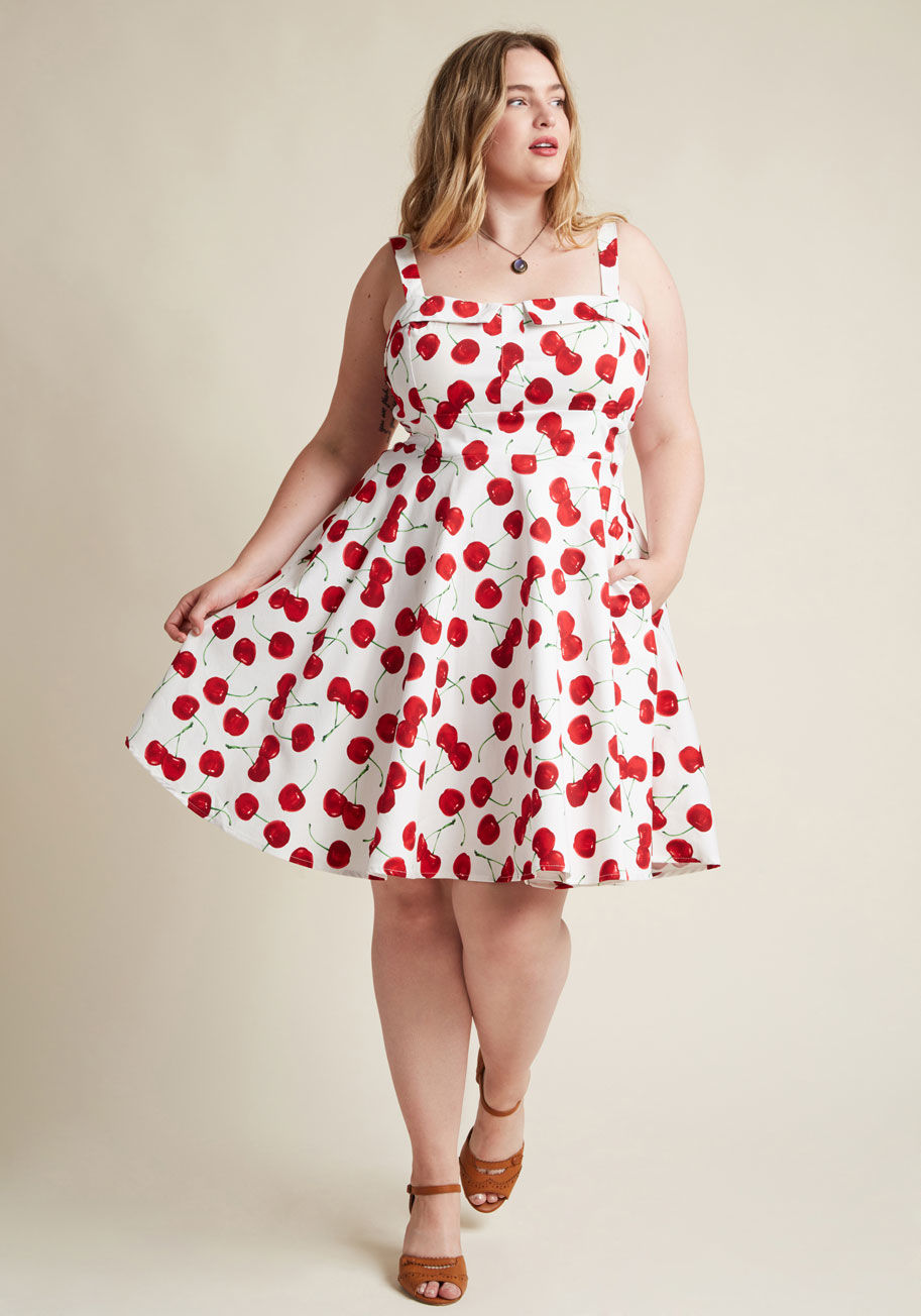 3582 - Strutting stylishly past the cafe, you overhear onlookers rave about that &ldquo;rockabilly diva's beautiful white dress! With a collared-and-padded bust, one-inch straps, and a swingy, A-line cut that's patterned with red cherries, your cool back-tied fr