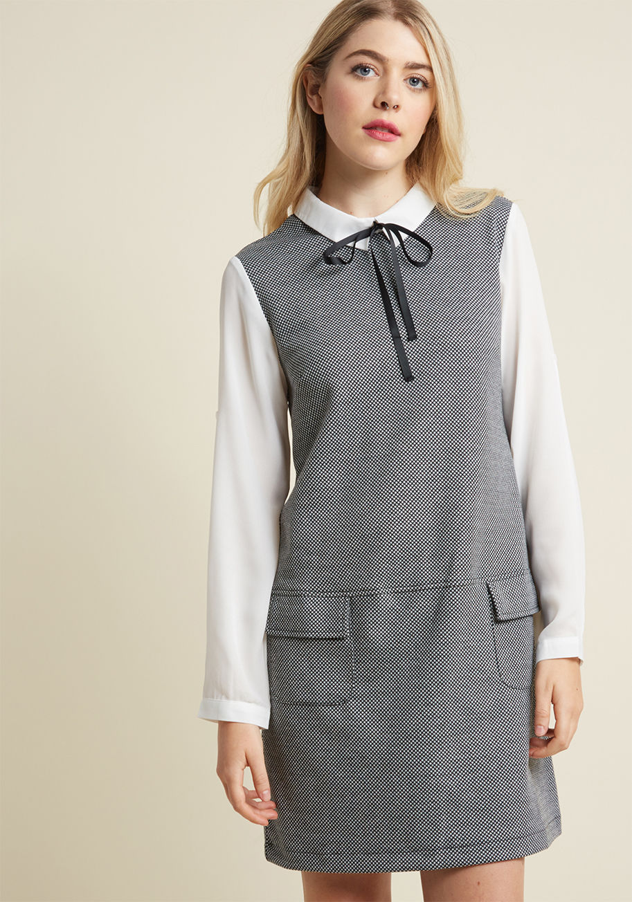 40902 - When it comes to picking a piece that embodies your favorite era, this retro tunic makes the choice obvious! Able to be worn as a dress or lengthy top with its white chiffon collar and matching tab sleeves, grosgrain neckline tie, black diamond knit fabri