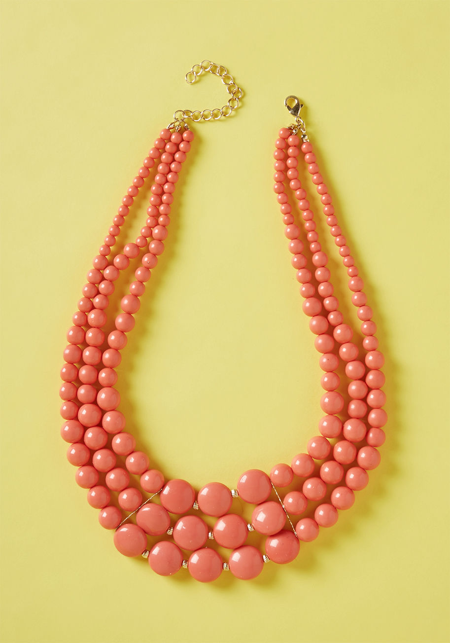 447287N-001 - Take a 'bright' out of life each time you style this tiered necklace! Rows of coral beads add color to any neckline, making statement style commonplace
