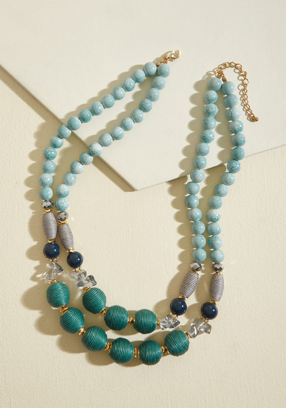 With the simple addition of this beaded necklace, you take your look from sweet to complete! Dual strands of green, blue, and grey beads add texture and intrigue to this eye-catching accessory, as its gold accent hardware provides the perfect touch of shi by 451075N-103