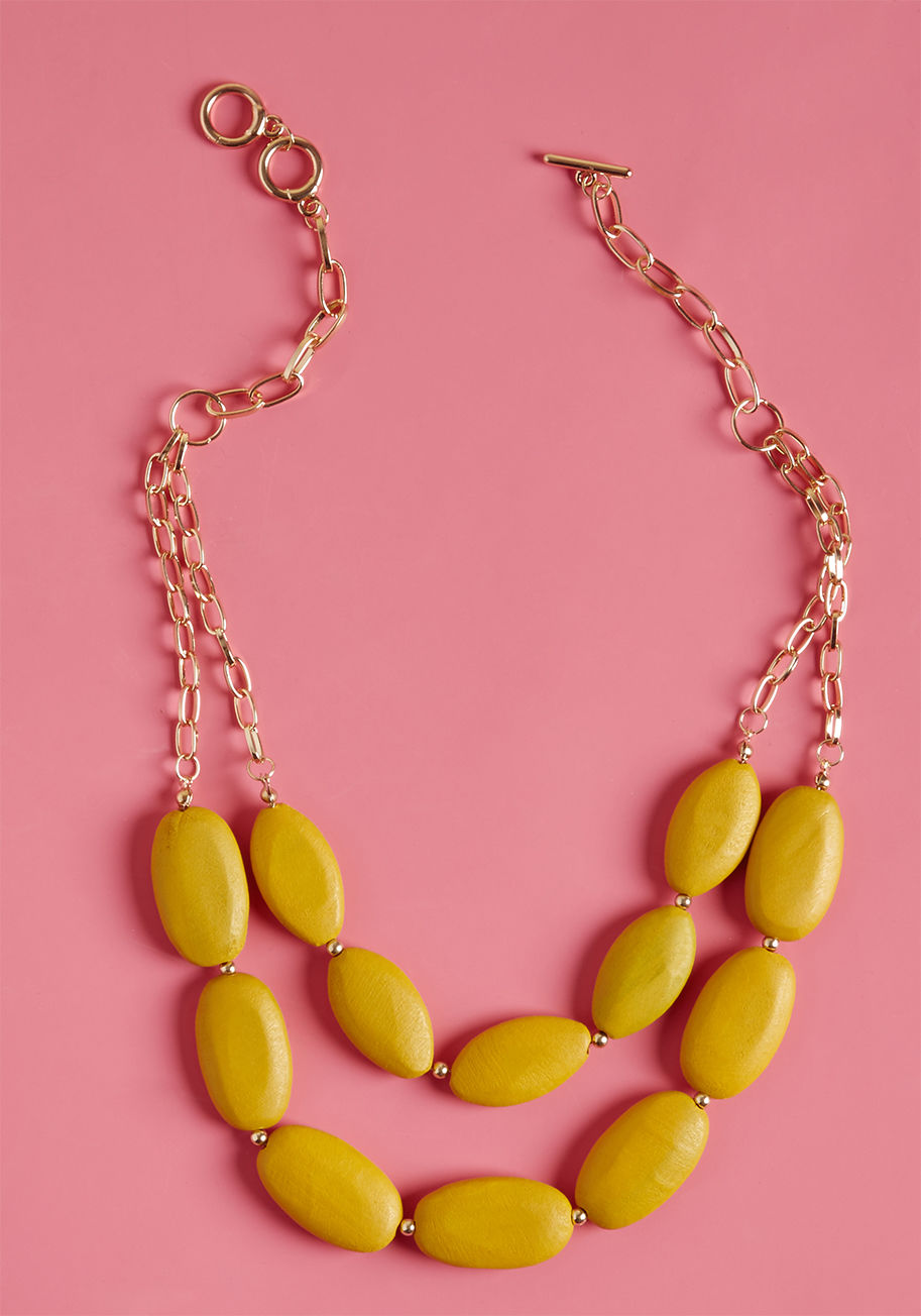 456343N-101 - What good is a bright, beaded necklace if you aren't going to enjoy every moment of showcasing it? This two-tiered accessory is a ModCloth exclusive designed with oblong, gold chain links and ovular wooden beads, boasting a brilliant goldenrod color that'