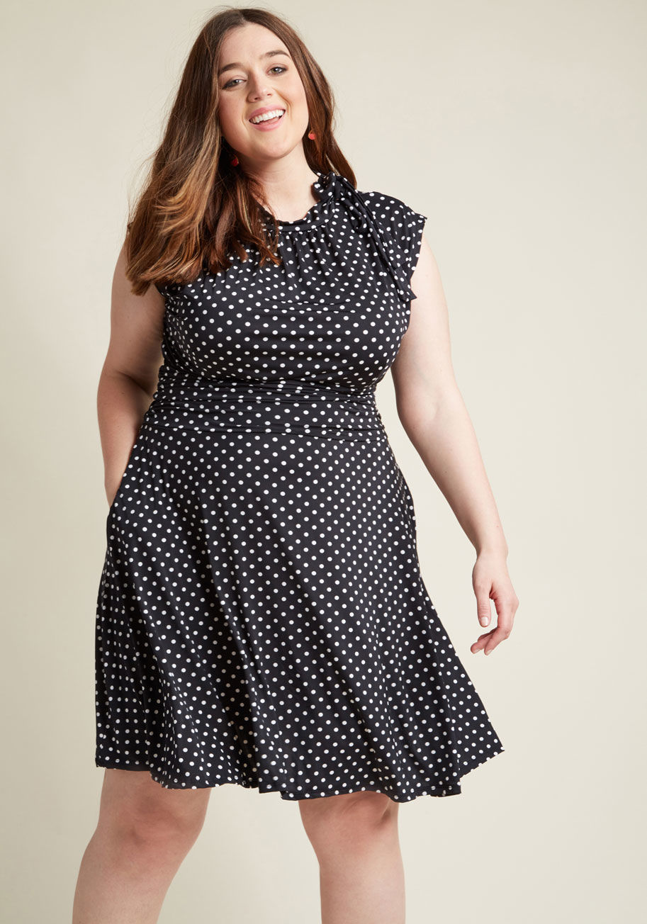 555 - Jump into this black, dotted frock and meet your darling on the dance floor! The bow-topped neckline of this sassy look from Retrolicous bounces with your every tango step, while the ruched details hug your waist as you flash your footwork! With a retro-i