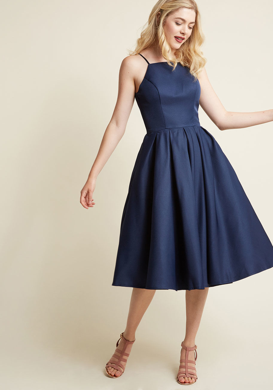 7362BL - In this gorgeous navy fit and flare by Chi Chi London, you prove that the most magnificent statement is sticking to the sweetest classics. A style enriched with a tapered neckline, tailored bodice, and perfectly pleated waist, this most gorgeous midi sets