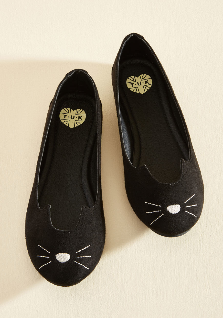 A9008L - Fetching, fierce, and infinitely adorable - that&rsquo;s how you describe these cute ballet flats from T.U.K.! This black, vegan faux-suede pair features ear details and an embroidered cat face so you can pounce on countless opportunities for standout sty