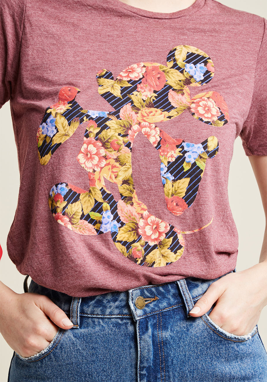 Today's dilemma - you can't decide whether to style this graphic T-shirt with skinnies or a skirt. Either way, you can't go wrong! This heather burgundy top's Mickey Mouse silhouette is fabulously filled with florals and stripes - a feminine nod that make by A9369KAFI