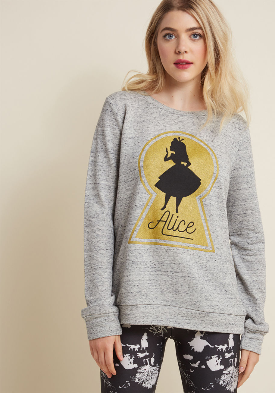 A9370AXT1 - Before you go exploring the worlds of your imagination, enlist this grey sweatshirt as your reliable companion! Traveling down the rabbit hole is made even more exciting with the black heathering and gold Alice graphic of this pullover faithfully by your 