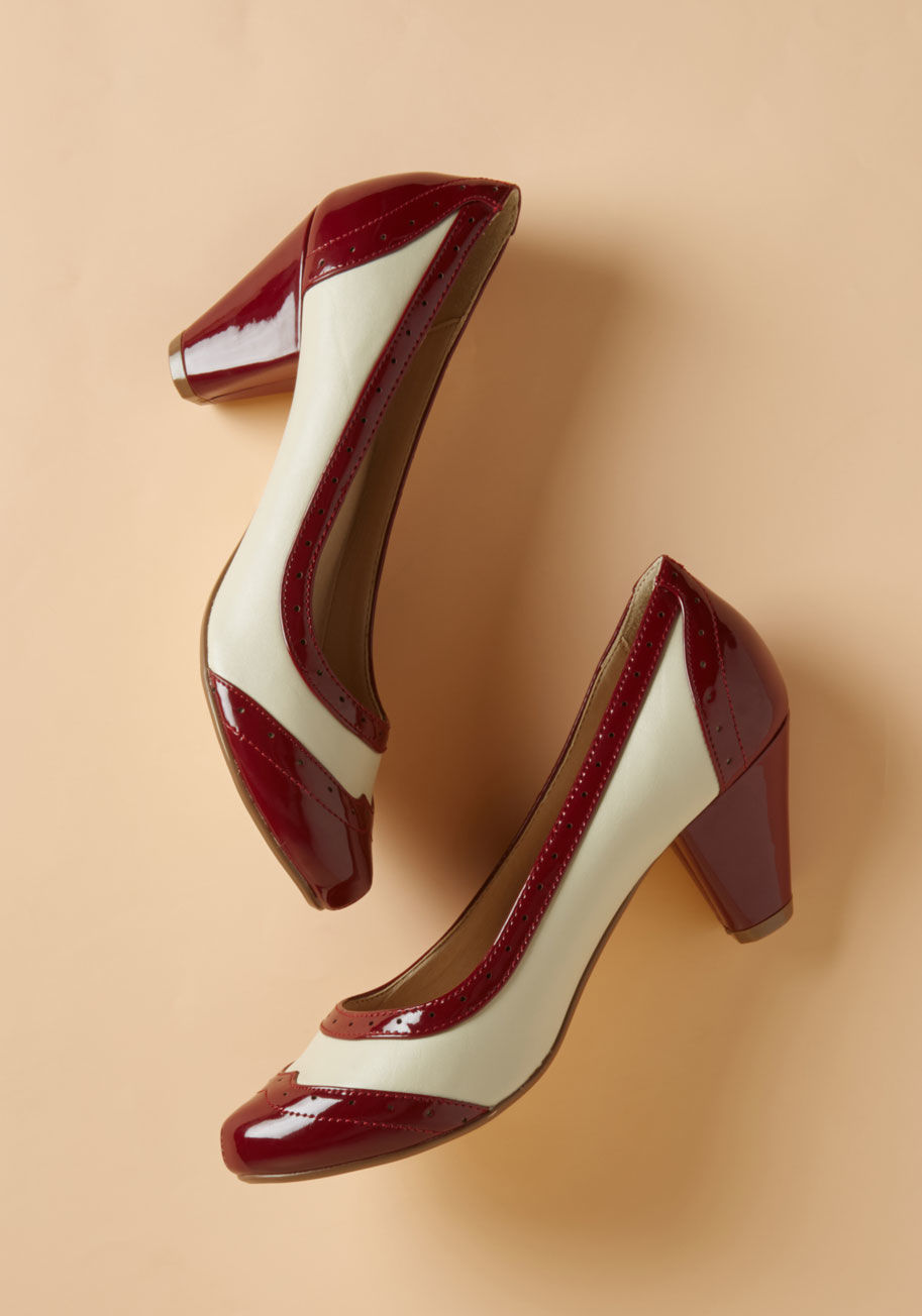 Audrey - What's that you hear? Why, it's these glossy pumps speaking directly to your retro sensibilities! Encouraging your outfit to adopt some nostalgic flavor with their burgundy and cream color scheme, perforated details, and timeless wingtips, these mid-heigh