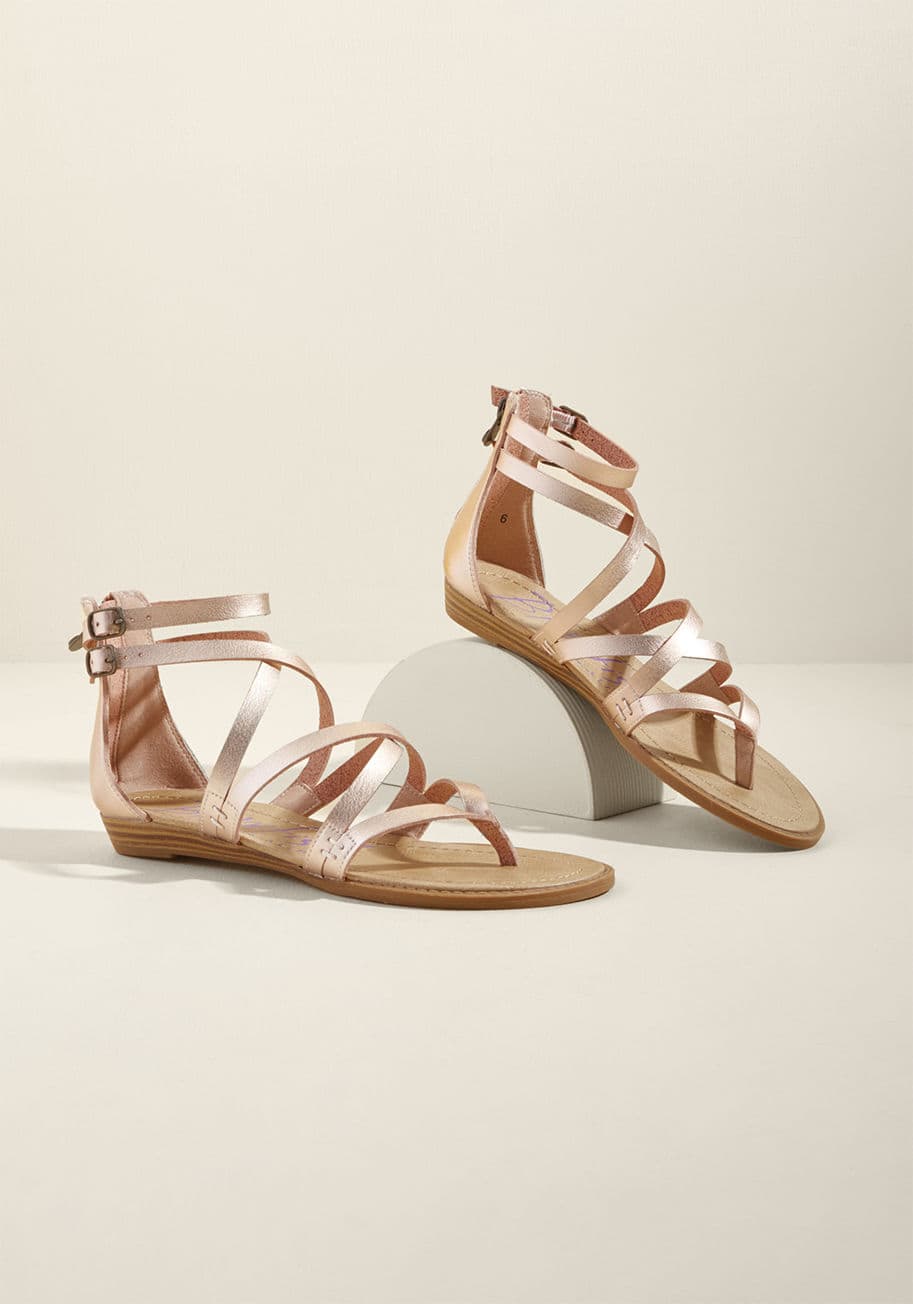 Bungalow - Once you zip into these metallic pink sandals by Blowfish, it&rsquo;s a &lsquo;dune&rsquo; deal - you&rsquo;re ready for the coast! Comprised of faux-leather straps, antiqued gold buckles, and low, stacked wedges, this pair makes &lsquo;shore&rsquo; you&r