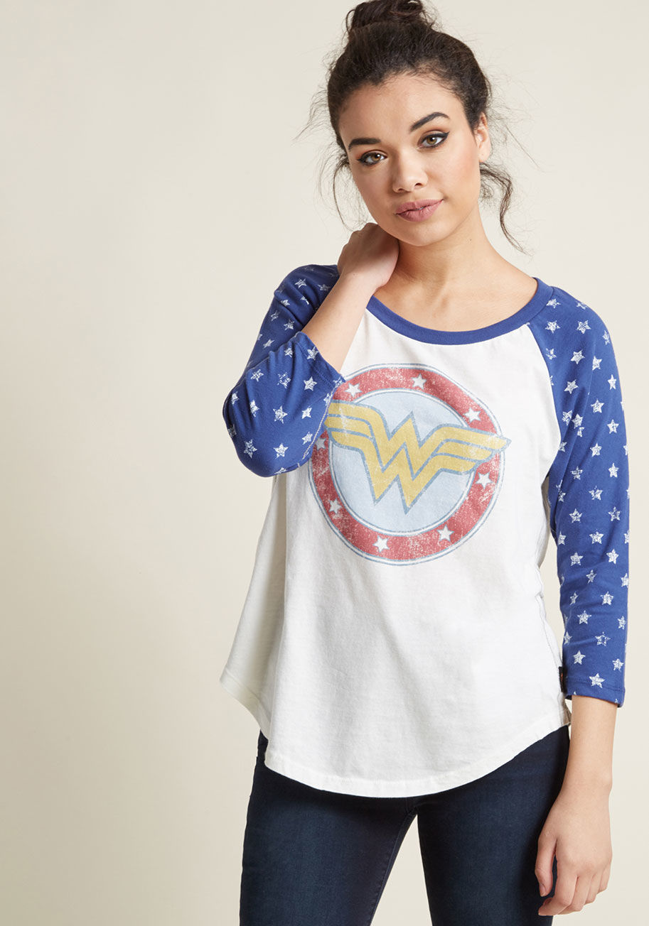 BW 3724 - No need to lasso the facts out of us - we're happy to declare our love of this Wonder Woman graphic tee! Heroically detailed with blue, star-spangled raglan sleeves and a central sigil of the Amazonian goddess herself, this USA-made top is a 'Diana Prince