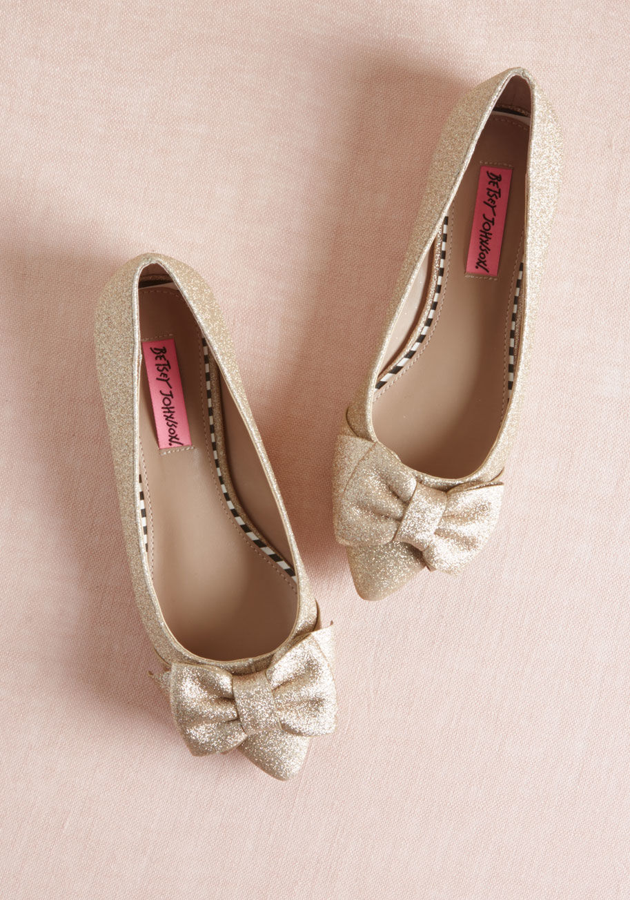 CINDI - Whether you're easing into glitter or you sparkle on the reg, you're sure to find these Betsey Johnson flats divine! In addition to being encrusted with champagne-hued glitter, these skimmers tout pointed toes topped with layered bows. So, while all eyes 