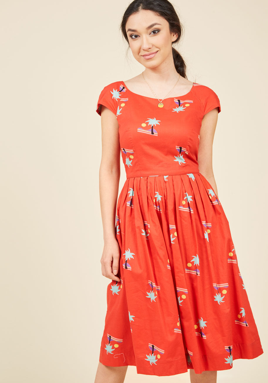 CLD-0210-CC - There's a lot to love about this dress by hard-to-find British brand Emily and Fin. In a vibrant crimson hue, this cotton A-line stars a ModCloth-exclusive print of colorful beachscapes, a bateau neckline, and a pleated skirt, making this vintage-inspired