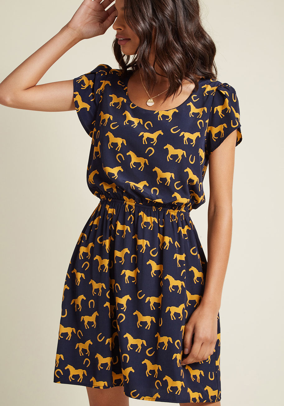 DP8441-4091A - Expressing your delight will be automatic as soon as you slip into this printed dress! A bevy of goldenrod horses gallop amid horseshoes across this navy blue, ModCloth-exclusive frock, adding a touch of whimsy to its tulip sleeves and adorably cinched wa