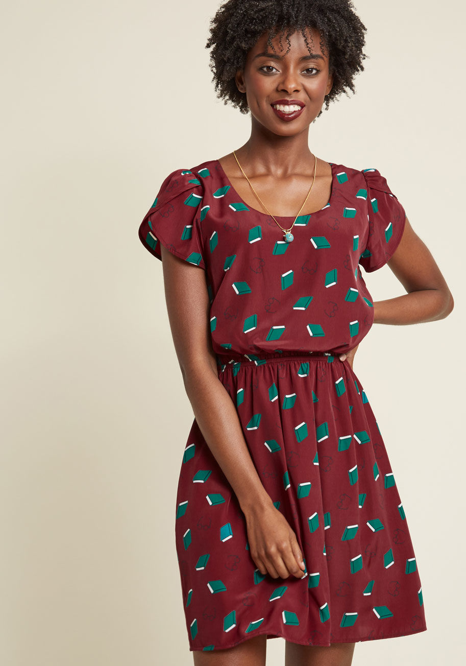 DP8441-4385A - Expressing your delight will be automatic as soon as you slip into this printed dress! A bevy of teal tomes and round, navy glasses float atop this burgundy, ModCloth-exclusive frock, adding a touch of whimsy to its tulip sleeves and adorably cinched wais