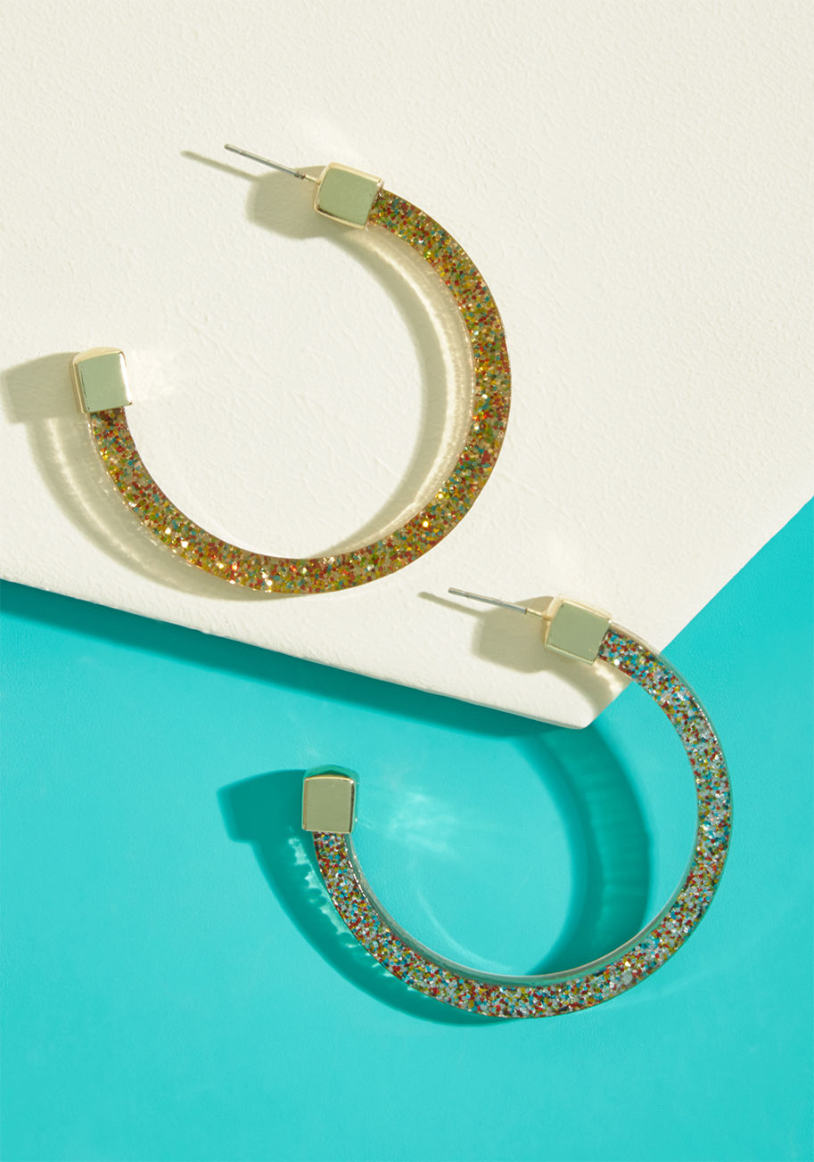 Take on the day with the genuine tenacity these hoop earrings inspire! Sparkling with glitter through their translucent frames, this gold-topped pair is a revved-up reminder that you can nail it on the daily. by EA66968