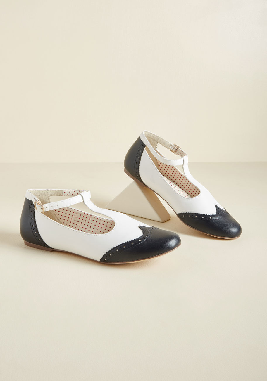 Emma - In addition to the soft picnic blanket, the company of your pals, and the packed lunch, these wingtip flats bring just as much glee to the afternoon! These faux-leather T-straps from B.A.I.T. Footwear put throwback fashion on the menu with their navy brog