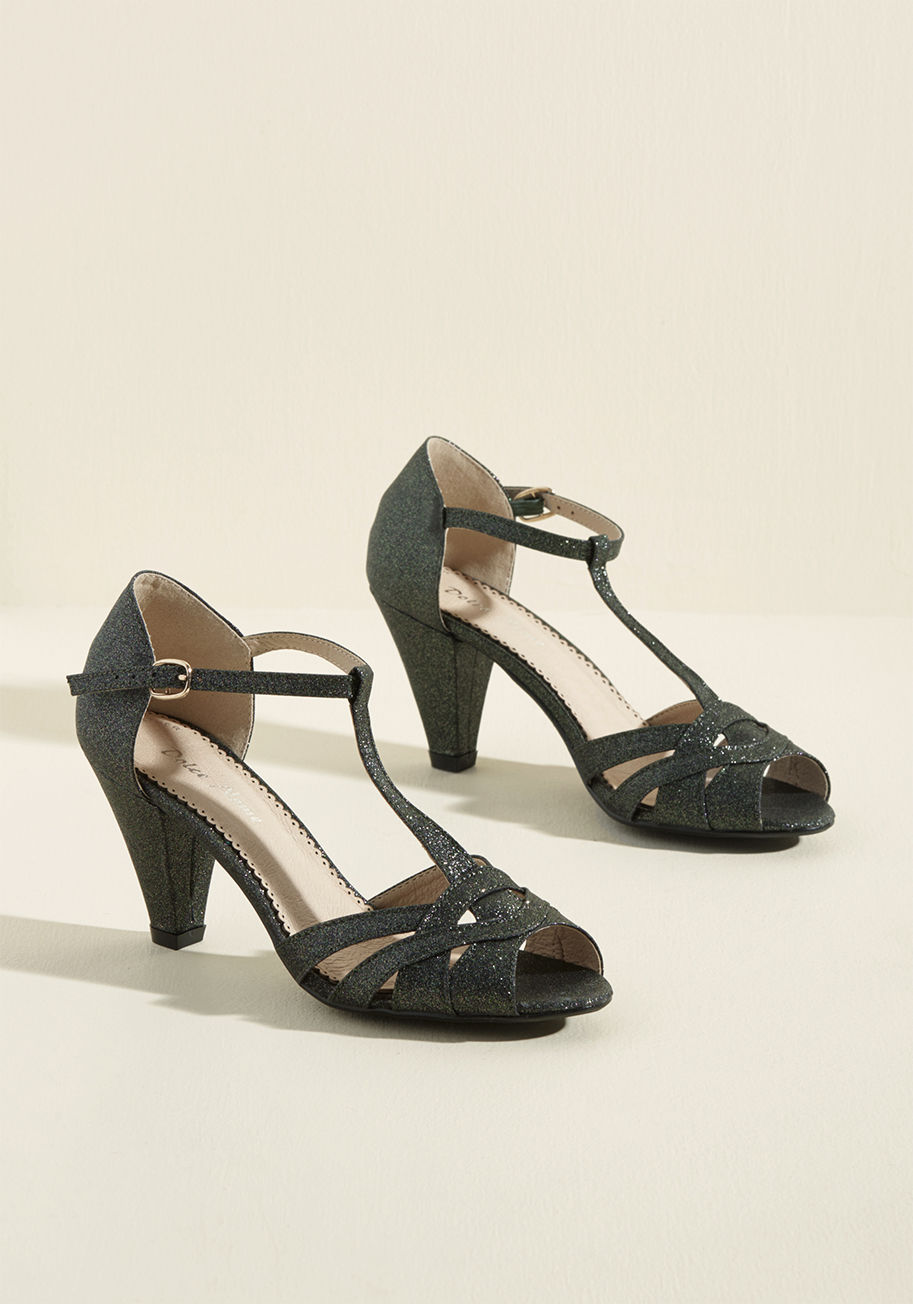 Florence - Treat yourself to these glittery T-strap heels - you know you wanna! In fact, you more than deserve the intricate straps, tapered pumps, and green-based sparkles of these leather-lined beauties, so take 'em for a spin to celebrate all that you do. It's ce