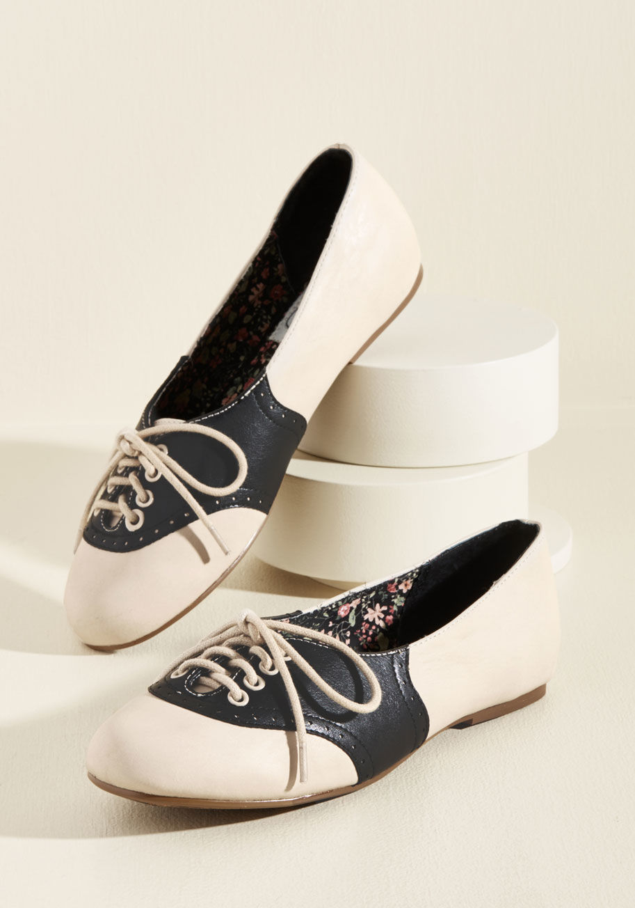 Halle - Lace up these Oxford-inspired flats by Bettie Page for your date with the library! Constructed partially from faux leather and flaunting delicate perforations atop a black-and-cream color scheme, these kicks are the cutest possible pair to help you with a