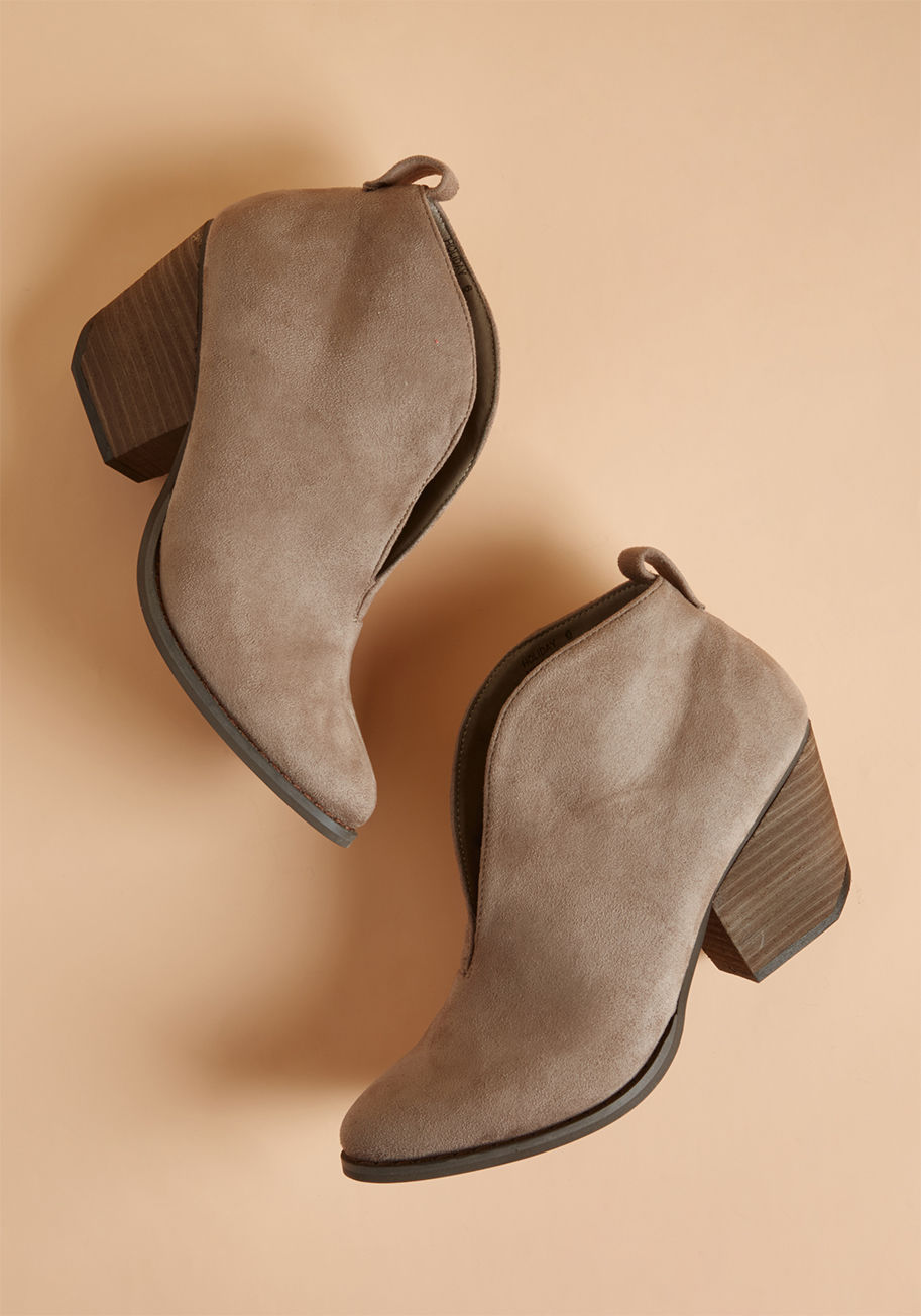 Holiday - Still have lingering questions about whether the fine design of these taupe booties will mesh with your overall wardrobe? Just picture the sleek, notched shafts, supple faux suede, and angular block heels of this utterly chic pair with your favorite piece