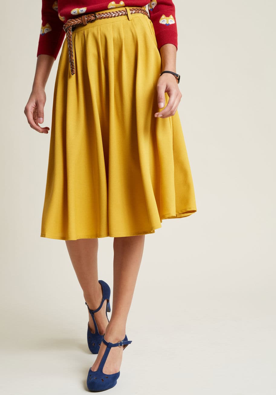 HS7024P - This morning, a bundle of bright flowers was waiting at your door. You excitedly scooped them up, deciding to wear this mustard midi skirt to match the beauty of their petals! You clasp the braided faux-leather belt through the loops that sit along this b