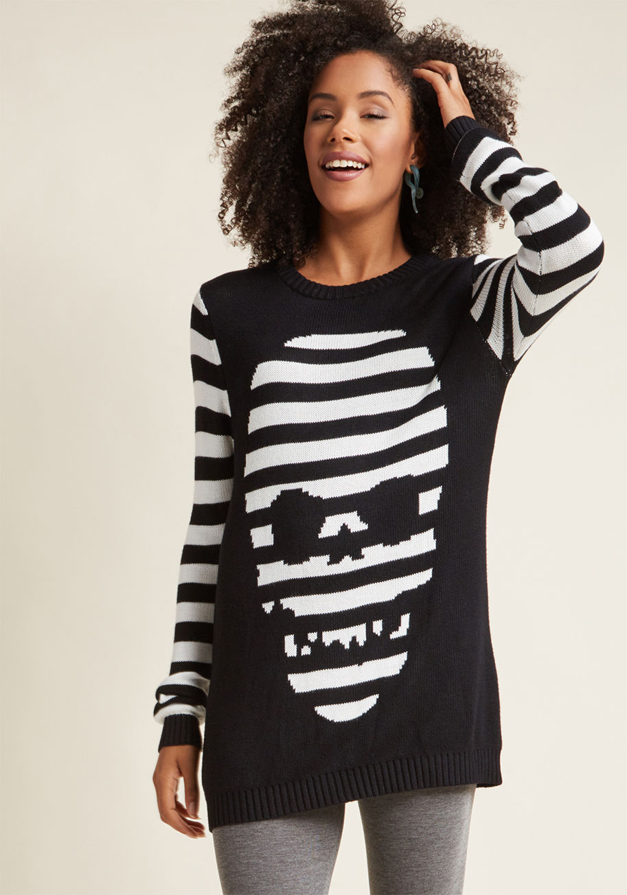 Warning - do not wear this super-soft sweater from Banned unless you desire loads of compliments! With the ability to be worn as either a sweater dress or a long top, this black-and-white striped layer - featuring an intarsia skull design - will have all  by JP1541
