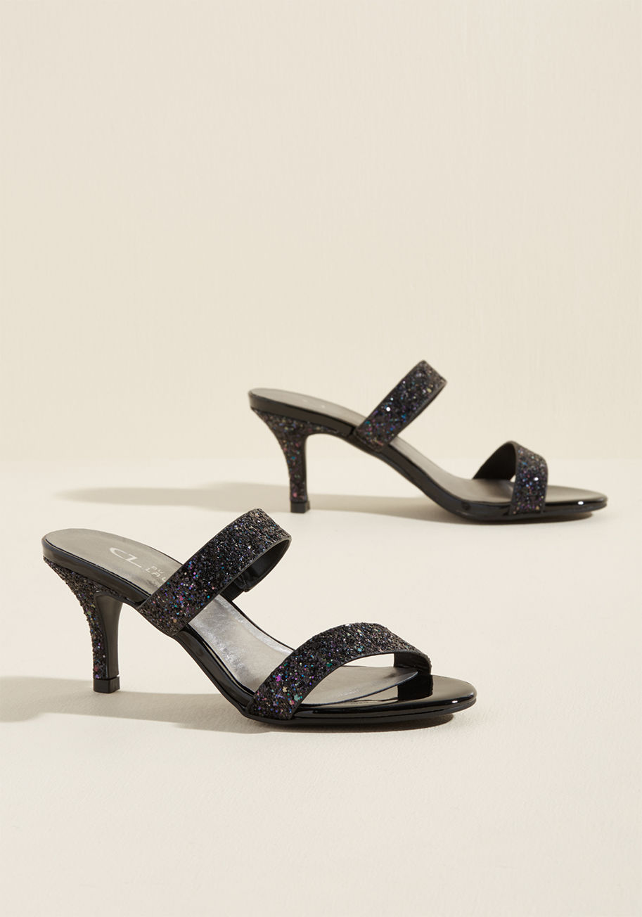 Juliett - Mirror mirror on the wall, who's the shiniest pair of them all? If these black heels could speak, that's the question they'd pose! It's up to you to assure them that their mini pumps, dual straps, glitzy glitter, and slip-on silhouette make them the most 
