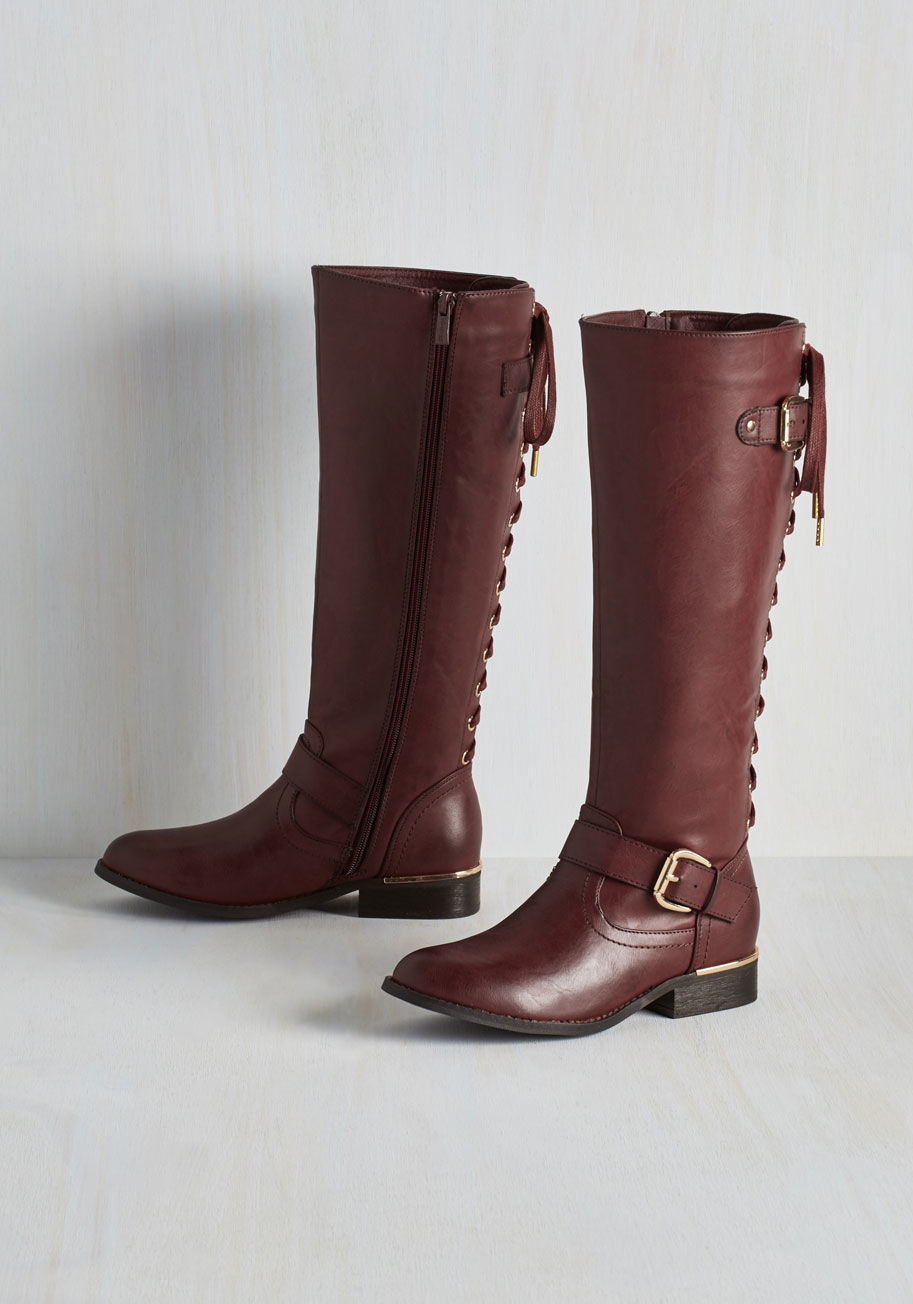 Lounge - You've been curating a spectacular collection of footwear, and upon adding these burgundy boots, your compilation is complete! This vegan faux-leather pair touts a lace-up back with gold hardware and a subtly stacked heel that showcases your fashionable p