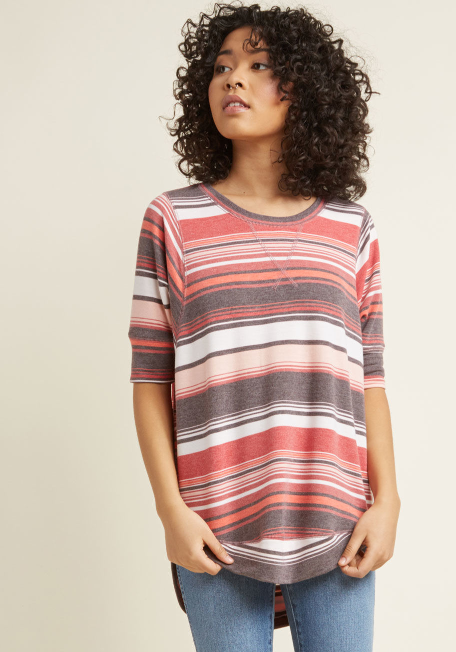 MC-1075 - This striped top is always number one on your list of wardrobe faves! Complete with a high-low hem and a relaxed, dolman-sleeved silhouette, this soft, red, pink, grey, and white shirt provides the foundation for infinitely fresh and feminine looks. Psst 