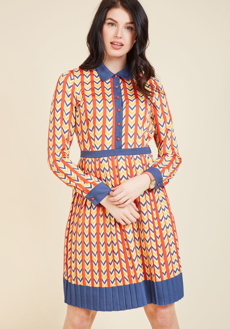 As eclectic as the memos you transcribe, but as tidy as your organized desk, this retro shirt dress shows your colleagues you mean business! A pocketed part of our ModCloth namesake label, this pleated frock flaunts a primary-colored chevron pattern, a bu by MCD1063