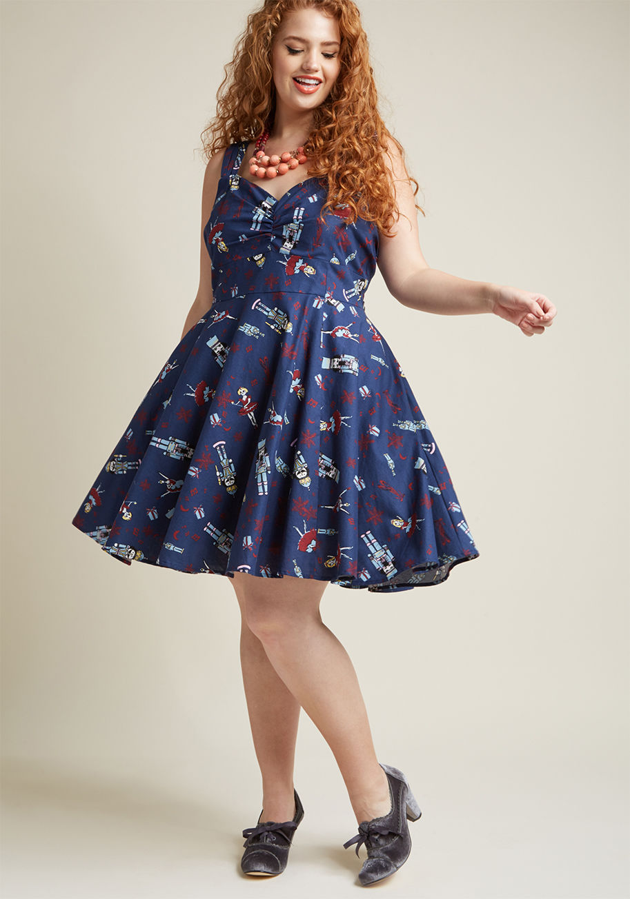 When your guests finally arrive, it's hard to say what they're happier to see - the sumptuous feast, or this navy blue dress! Boasting a sweetheart neckline, ruched bust, and faux-leather belt topping its burgundy, sky blue, and ivory nutcracker print, th by MCD1444A