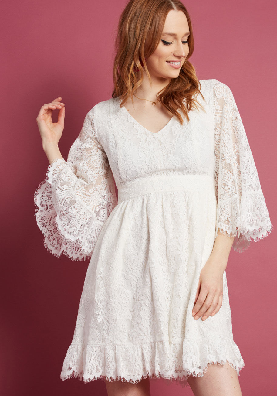 MCD1569 - Your day off is dreamy as can be thanks to this vintage-inspired, lace dress - part of our ModCloth namesake label! Flaunting the sweet cream hue and back-tied waistband of this angel-sleeved frock, you sway to a blossom-lined pathway nearby, giving the n
