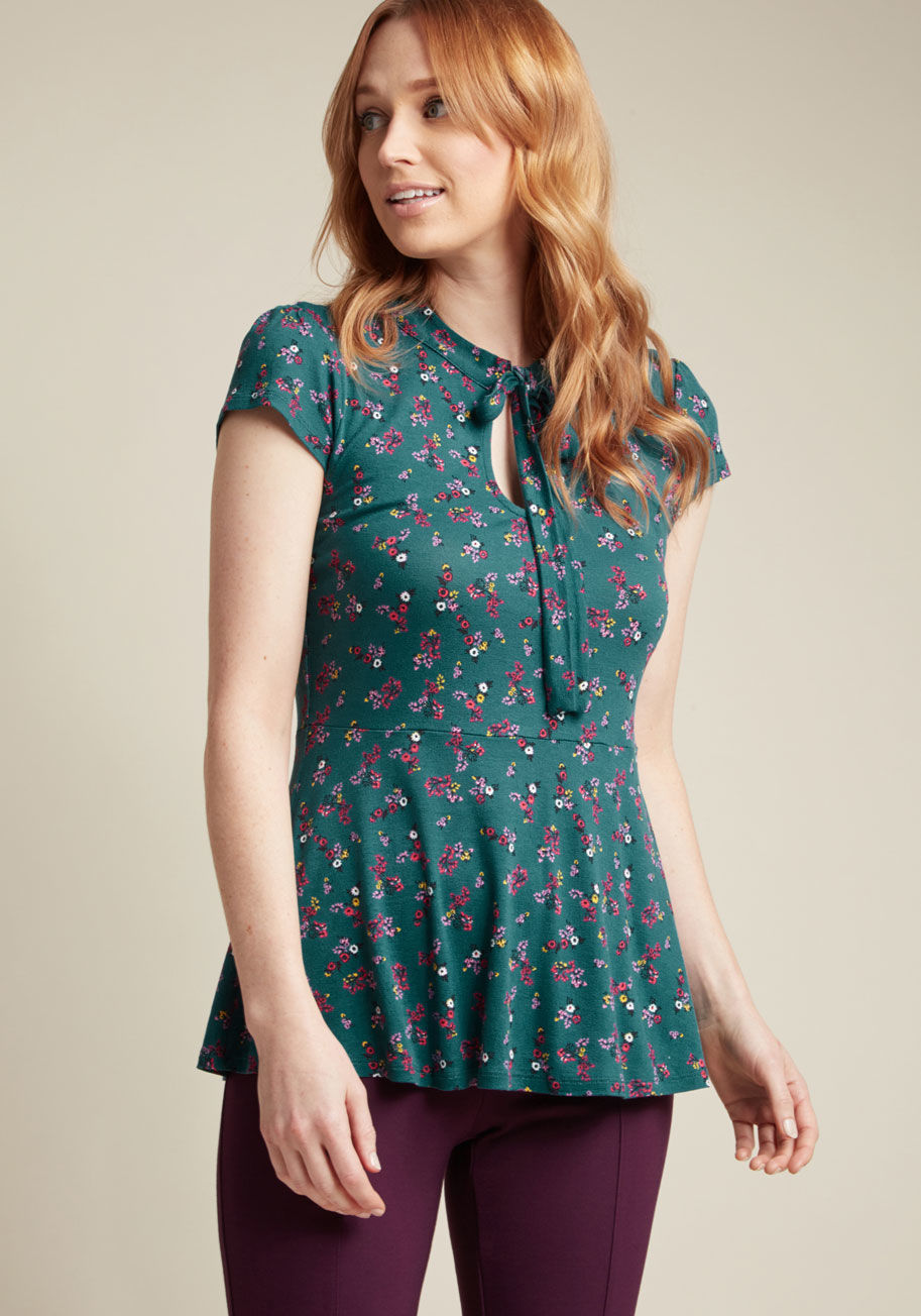 MCT1140B - Are you up for a look that's enlivened with flirty detailing and fun florals? Then turn your attention to this green top from our ModCloth namesake label! Between the lightly puffed shoulders of this knit number is a tied neckline, situated elegantly atop