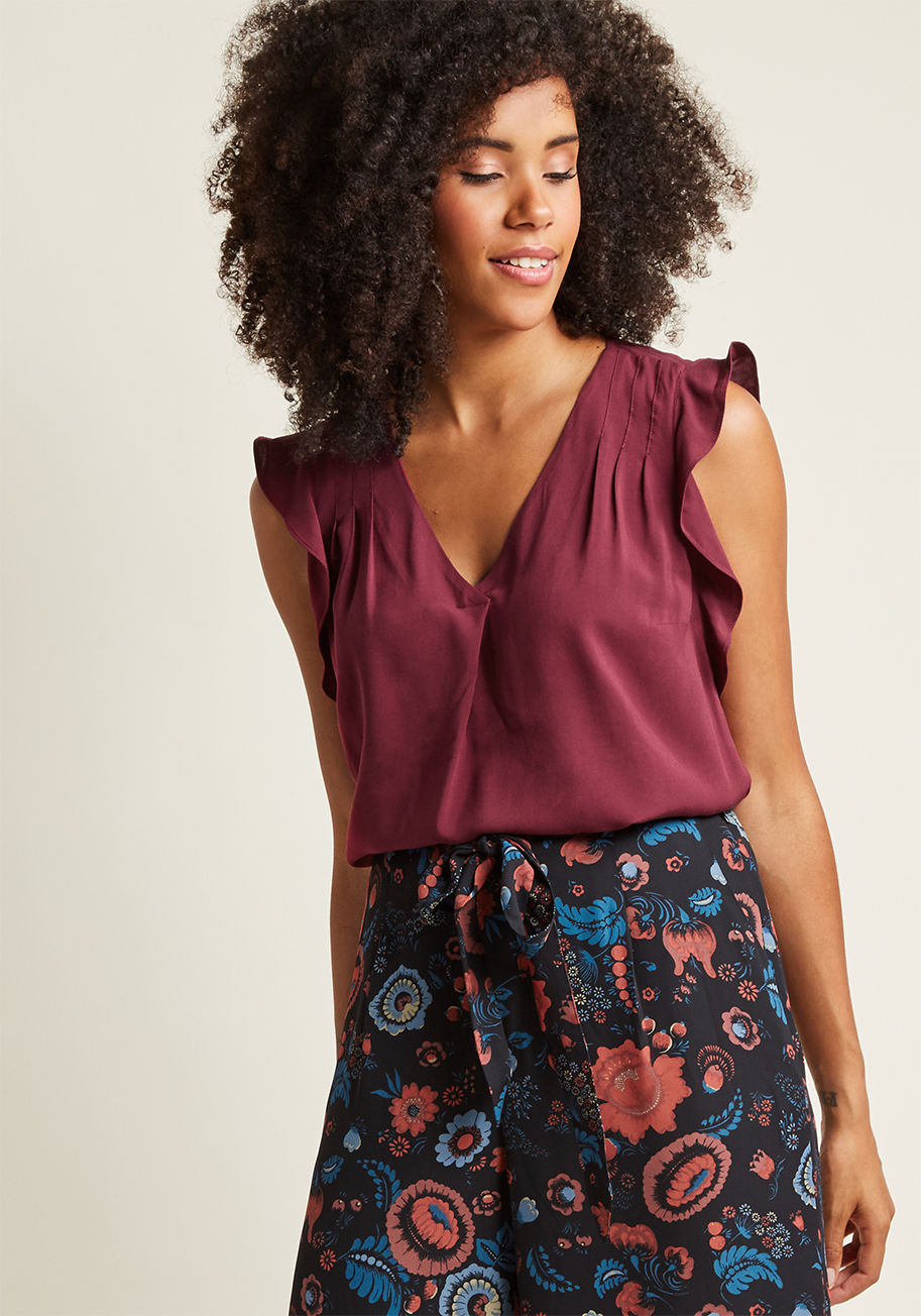 MCT1449 - You'll take your sophistication with a hint of flair, courtesy of this burgundy work blouse from our ModCloth namesake label! Precise pintucks accent the ruffled shoulders of this solid separate, pairing with a unique V-neckline pleat to generate creative